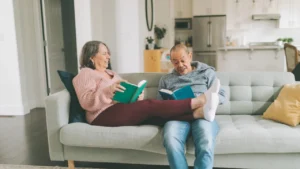 Happy married couple sitting on a couch having a good time.
